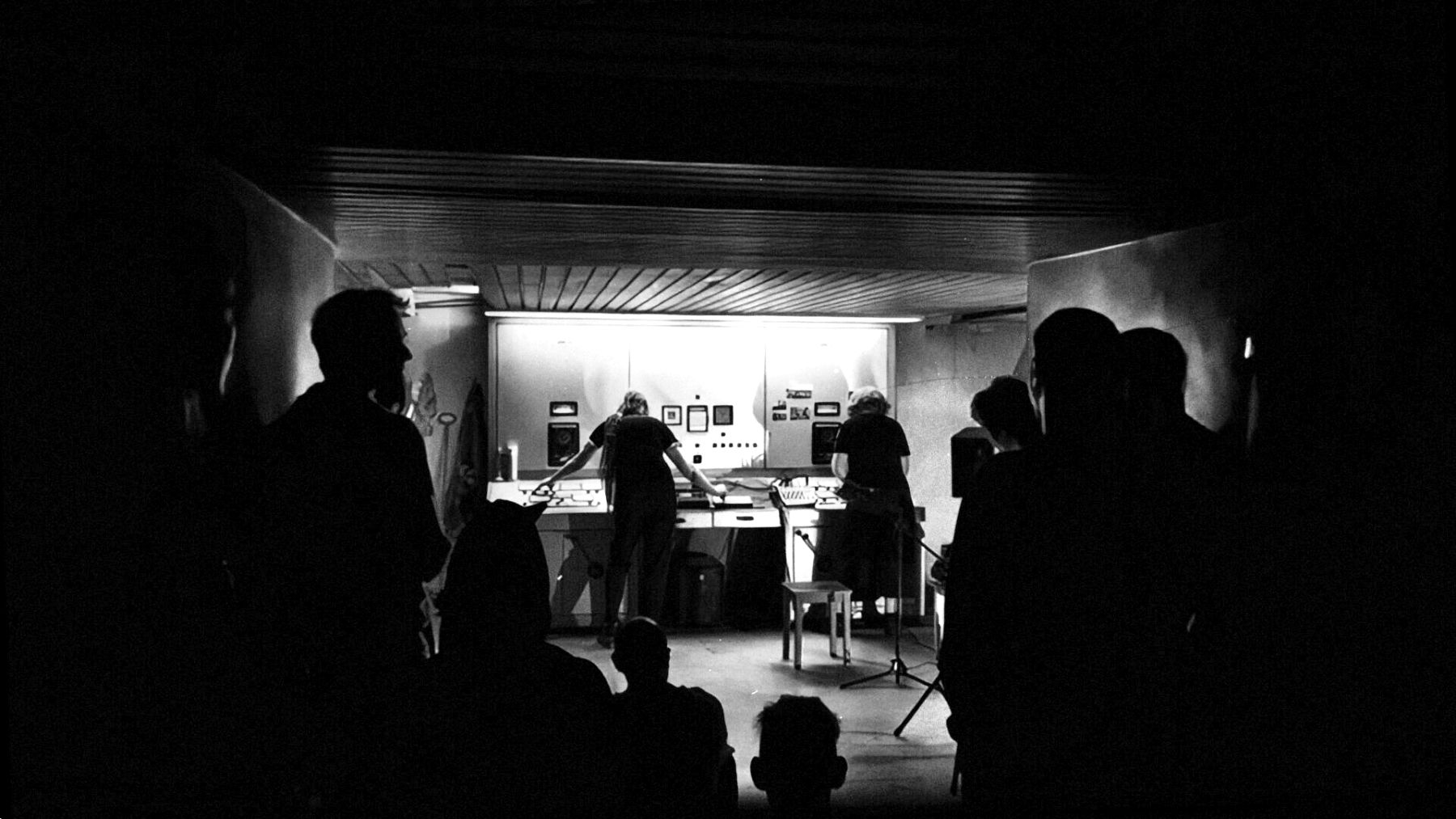 Audience silhouettes in front of the control-room stage